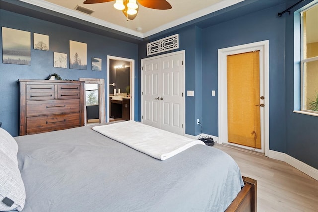 bedroom featuring ceiling fan, connected bathroom, a closet, and light wood-type flooring