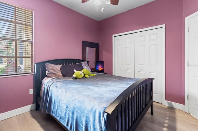 bedroom with wood-type flooring, a closet, and ceiling fan