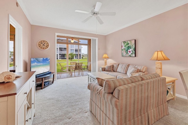 living room with crown molding, ceiling fan, and light carpet