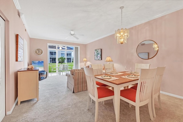 dining room with crown molding, light colored carpet, and ceiling fan with notable chandelier