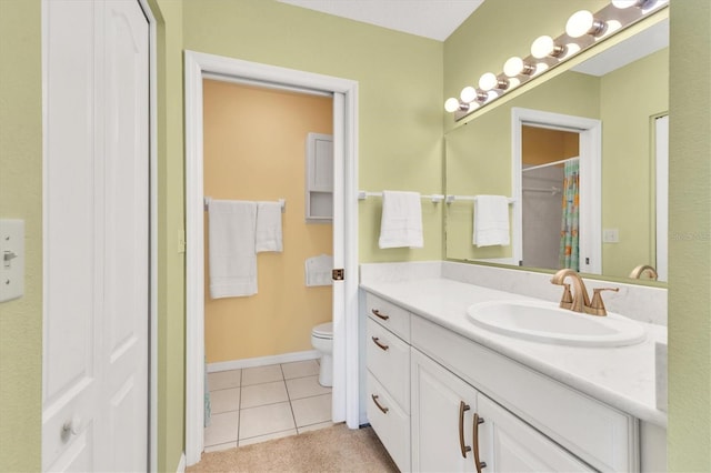 bathroom with vanity, toilet, and tile patterned flooring