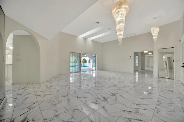 interior space with a towering ceiling and a notable chandelier