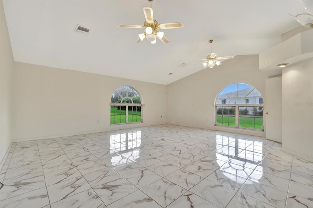 spare room with ceiling fan, vaulted ceiling, and a wealth of natural light