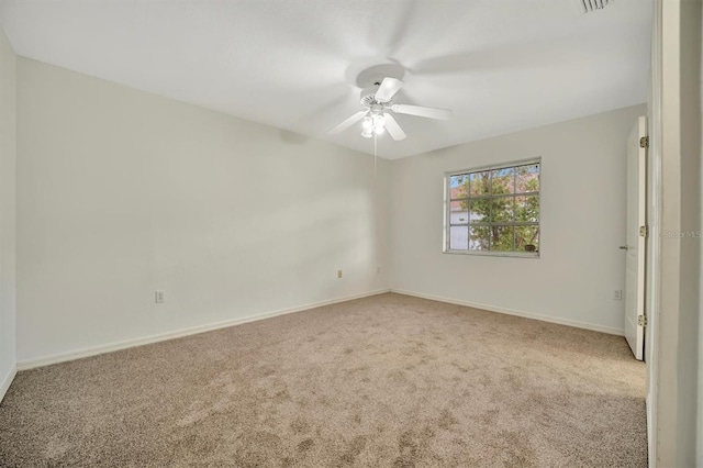 spare room with carpet floors and ceiling fan