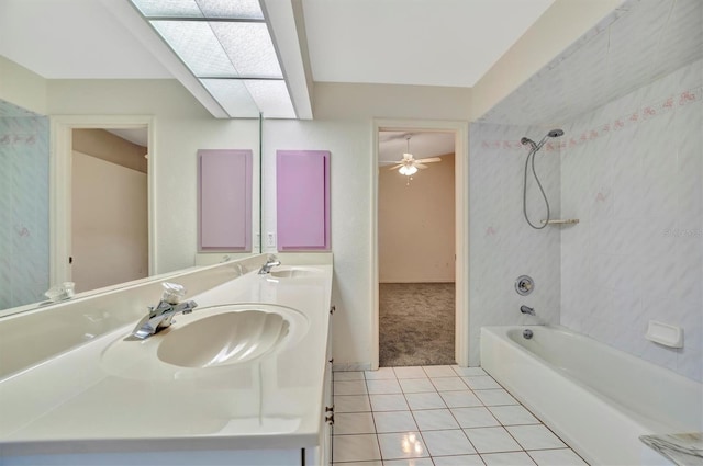 bathroom with vanity, tile patterned floors, and tiled shower / bath