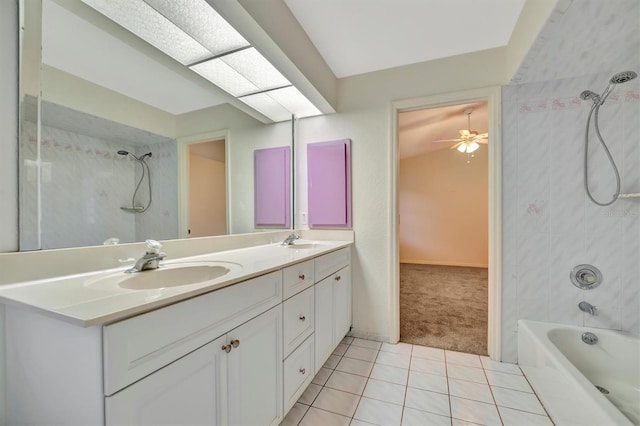 bathroom with tile patterned flooring, vanity, tiled shower / bath combo, and ceiling fan