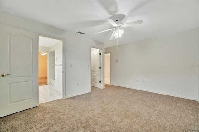 unfurnished bedroom featuring light colored carpet and ceiling fan