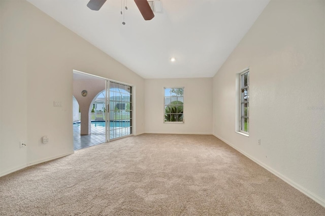 unfurnished room featuring vaulted ceiling, ceiling fan, and carpet