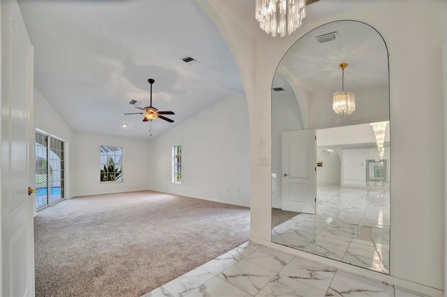 interior space featuring lofted ceiling and ceiling fan with notable chandelier