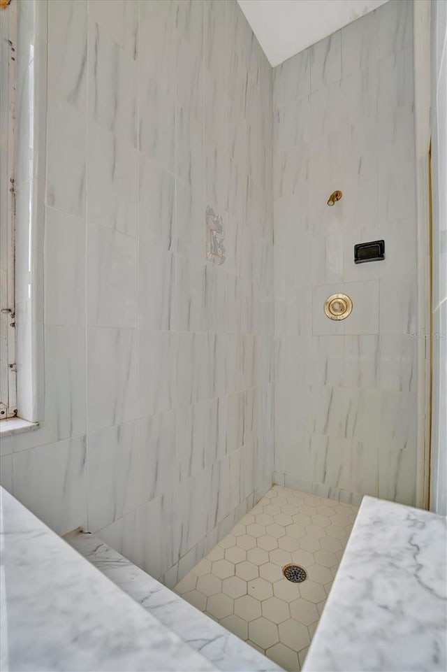 bathroom with a tile shower