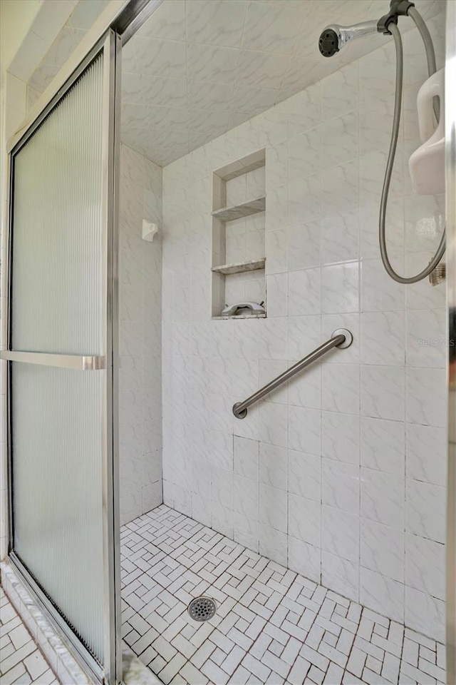 bathroom with a shower with shower door