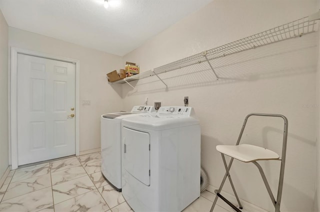 clothes washing area with washer and dryer