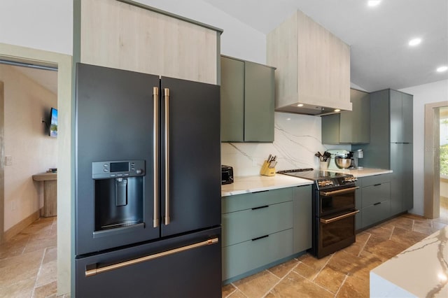 kitchen featuring green cabinets, decorative backsplash, and black appliances