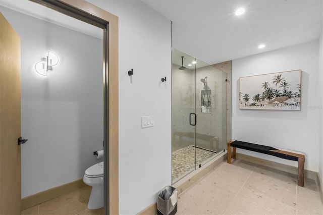 bathroom with tile patterned floors, toilet, and a shower with shower door