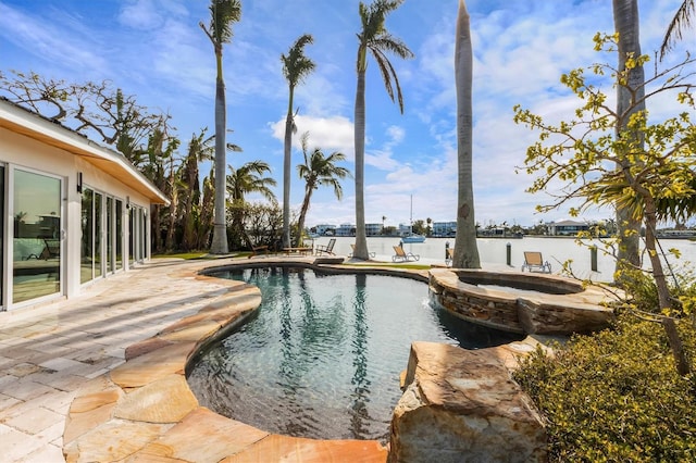 view of swimming pool with an in ground hot tub and a patio area