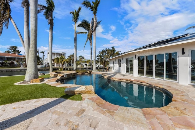 view of swimming pool featuring a water view and a patio area