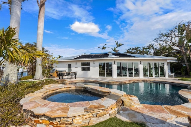 view of swimming pool featuring an in ground hot tub and a patio area