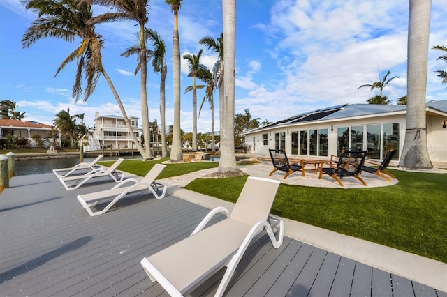 deck with a fire pit and a lawn