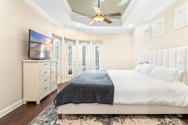 bedroom featuring access to exterior, ceiling fan, dark hardwood / wood-style floors, and a tray ceiling