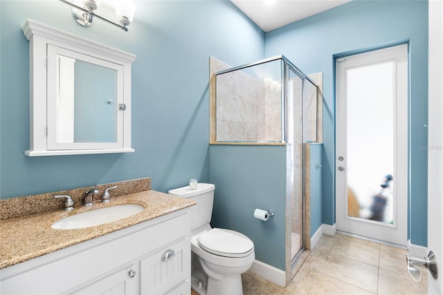 bathroom with toilet, a shower with shower door, tile patterned floors, and vanity