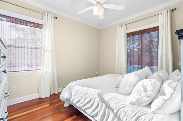 bedroom with ceiling fan, ornamental molding, dark wood-type flooring, and multiple windows