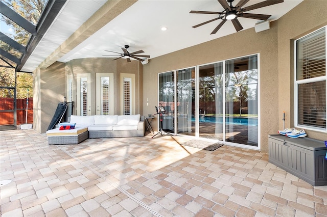 view of patio with an outdoor living space and ceiling fan