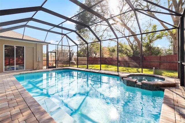 view of swimming pool with an in ground hot tub, a patio area, a lawn, and a lanai