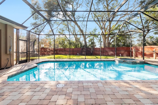 view of pool with an in ground hot tub, a lanai, and a patio