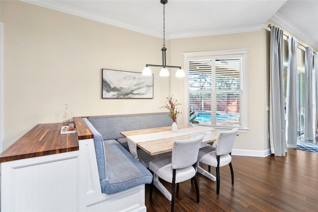 dining room with a notable chandelier, crown molding, and dark hardwood / wood-style flooring