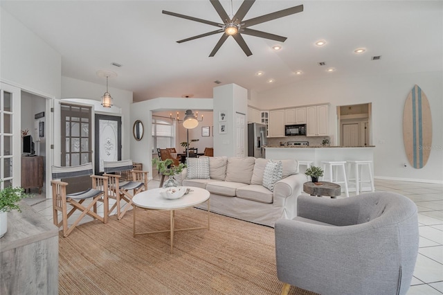 tiled living room with ceiling fan and lofted ceiling