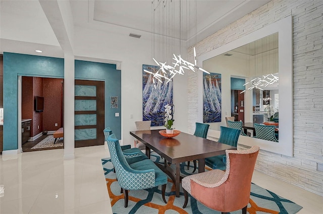 dining area featuring a high ceiling, visible vents, and light tile patterned flooring