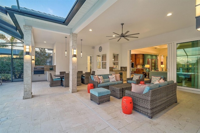 view of patio with exterior kitchen, outdoor dining area, outdoor lounge area, and a ceiling fan