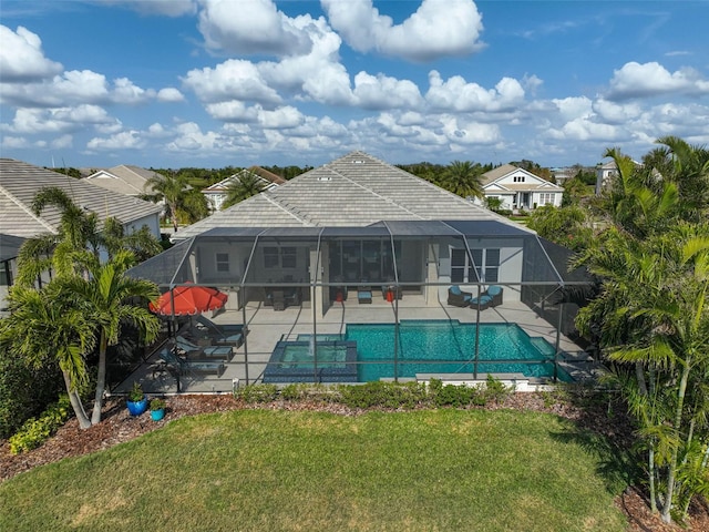 back of house with a patio, a lawn, a lanai, and an outdoor pool