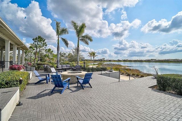 view of patio / terrace with an outdoor fire pit and a water view