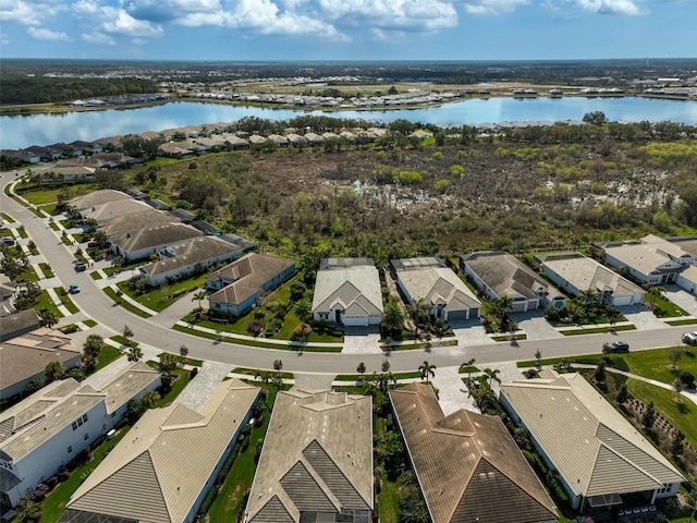 drone / aerial view featuring a water view and a residential view