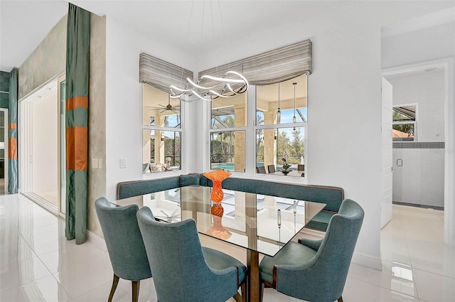 dining room with light tile patterned floors and a notable chandelier