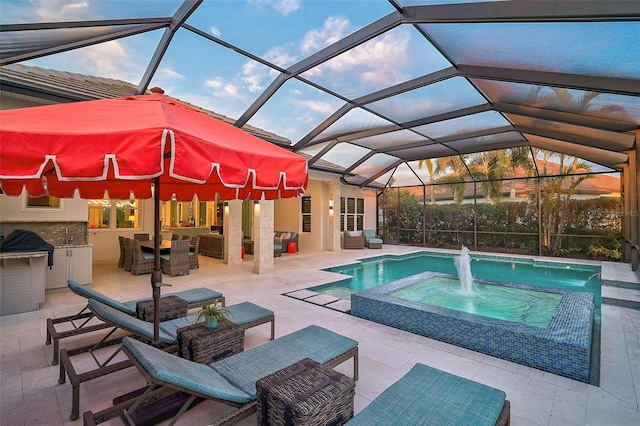 view of swimming pool featuring an outdoor hangout area, glass enclosure, a patio area, and an in ground hot tub