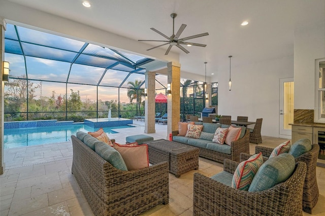 view of patio / terrace with glass enclosure, a grill, a pool with connected hot tub, an outdoor living space, and a ceiling fan