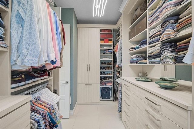 spacious closet featuring light tile patterned floors