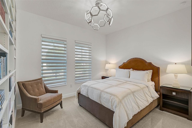 bedroom featuring light carpet and baseboards