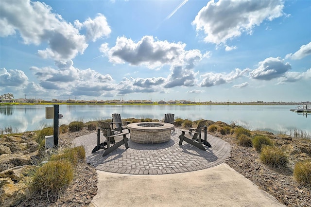 view of patio featuring an outdoor fire pit and a water view