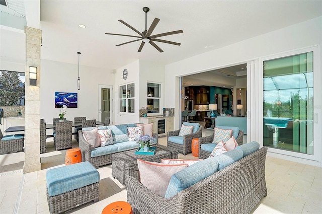 view of patio featuring outdoor dining area, outdoor lounge area, ceiling fan, and beverage cooler