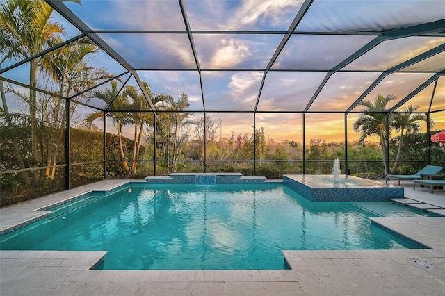 outdoor pool with a patio area and a lanai