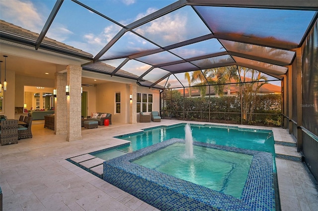 pool at dusk with glass enclosure, a pool with connected hot tub, an outdoor living space, and a patio