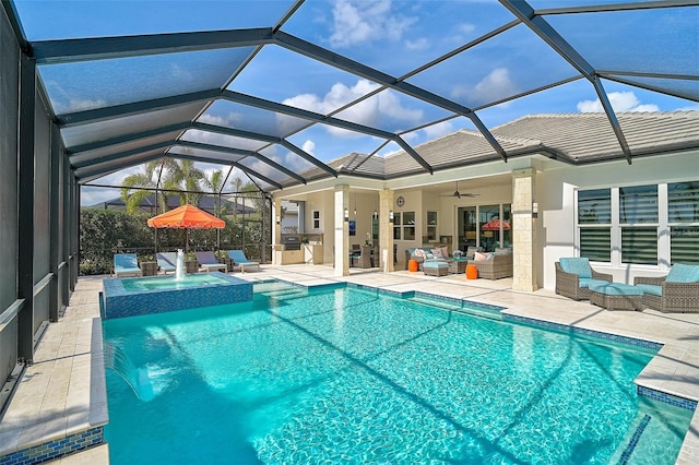 view of pool with a patio, a pool with connected hot tub, an outdoor hangout area, glass enclosure, and ceiling fan