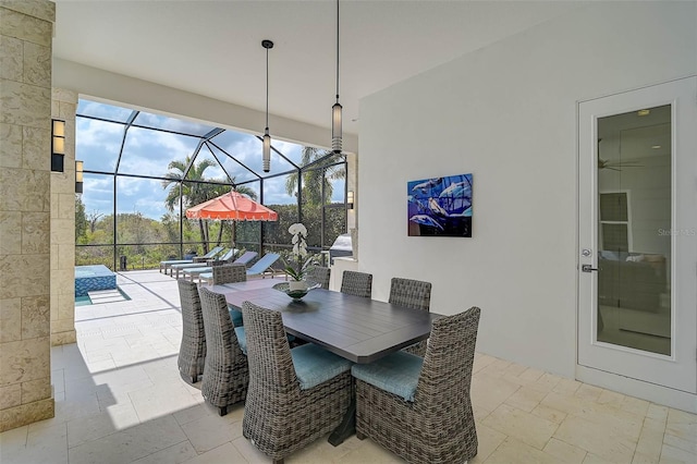 dining room with a sunroom and stone tile flooring