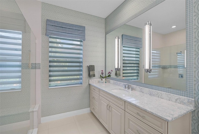 bathroom featuring a wealth of natural light, tile patterned flooring, and wallpapered walls