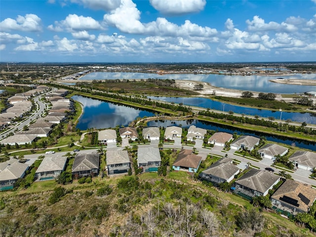 drone / aerial view with a water view and a residential view