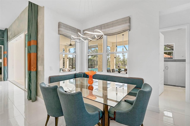 8261 Grande Shores Dr, Sarasota, FL 34240 - tiled dining room featuring a chandelier and baseboards