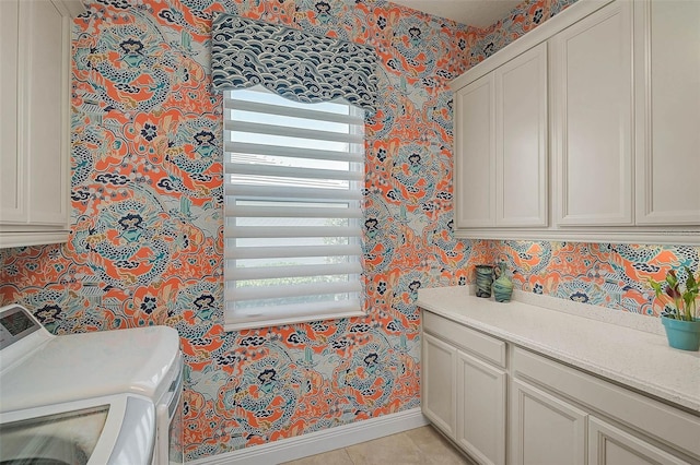 8261 Grande Shores Dr, Sarasota, FL 34240 - washroom with wallpapered walls, cabinet space, washing machine and clothes dryer, plenty of natural light, and light tile patterned floors